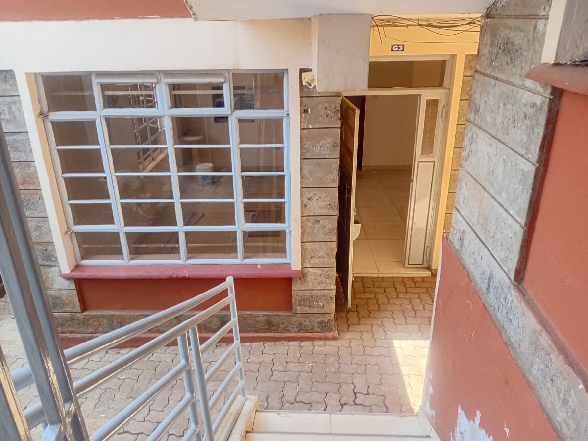 Residential entrance with metal gate and brick walls