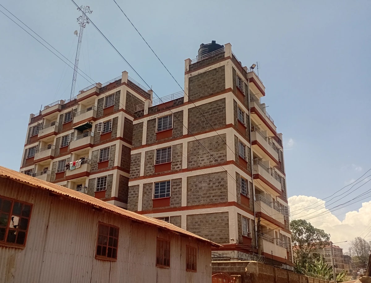 Multi-story residential building with stone and brick facade
