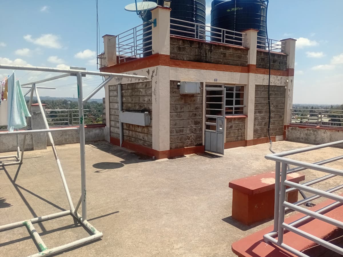 Rooftop under construction with water tanks and city views