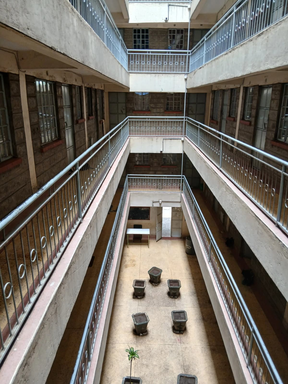 Multi-story interior courtyard with metal railings and seating