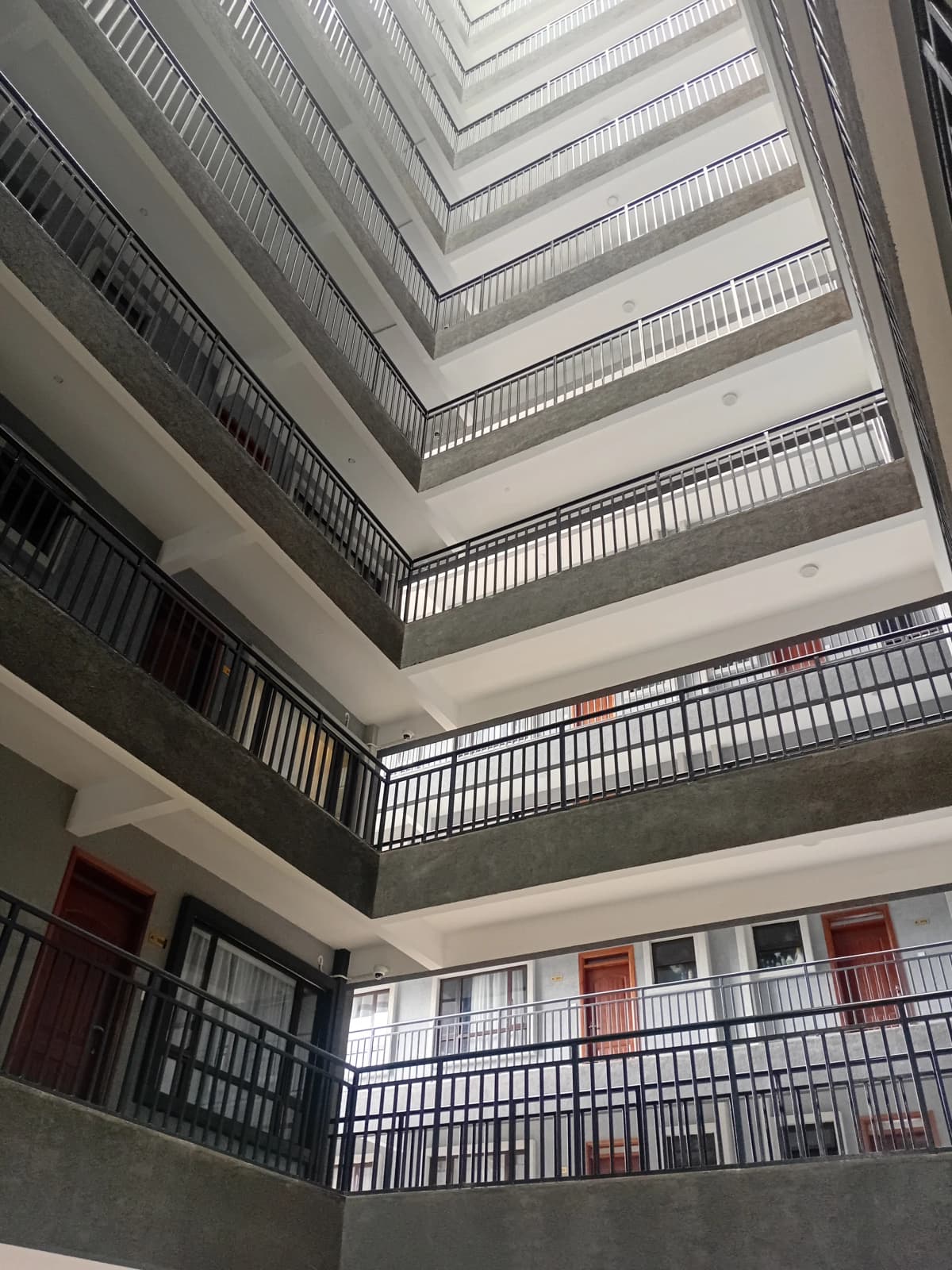 Multi-story atrium with stacked balconies and skylight