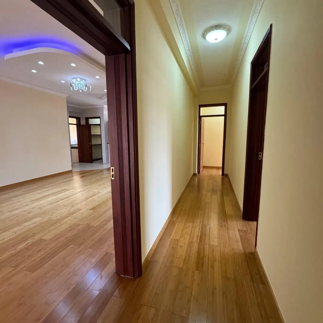 Modern corridor with wooden floors and ambient lighting