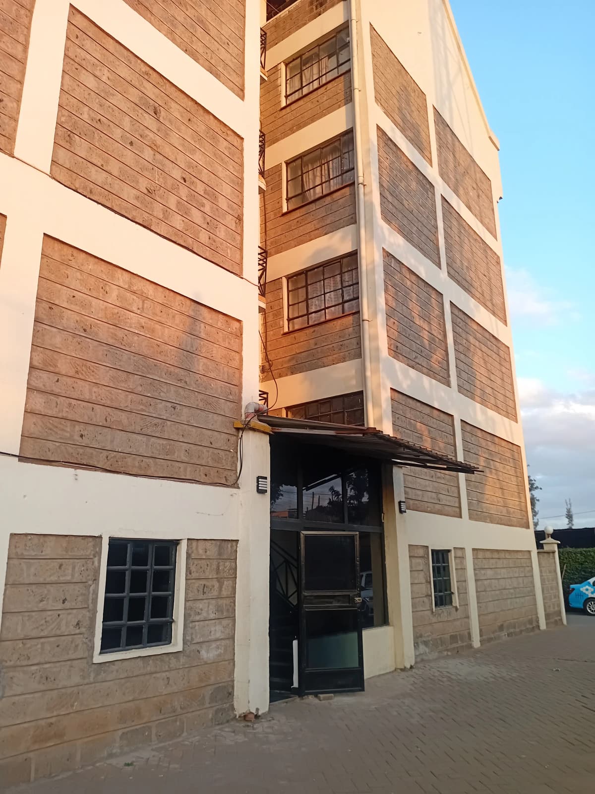 Multi-story apartment building facade with brick and cream finish