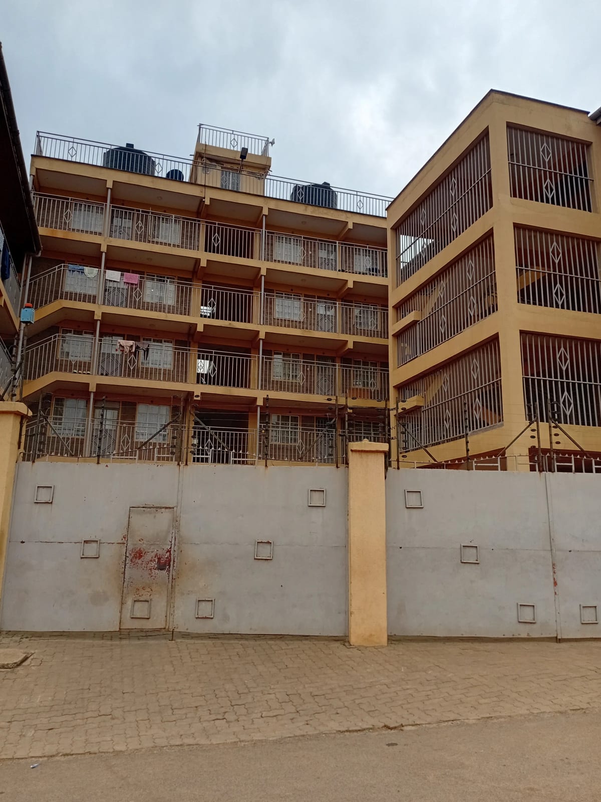 Multi-story residential building with yellow facade and balconies