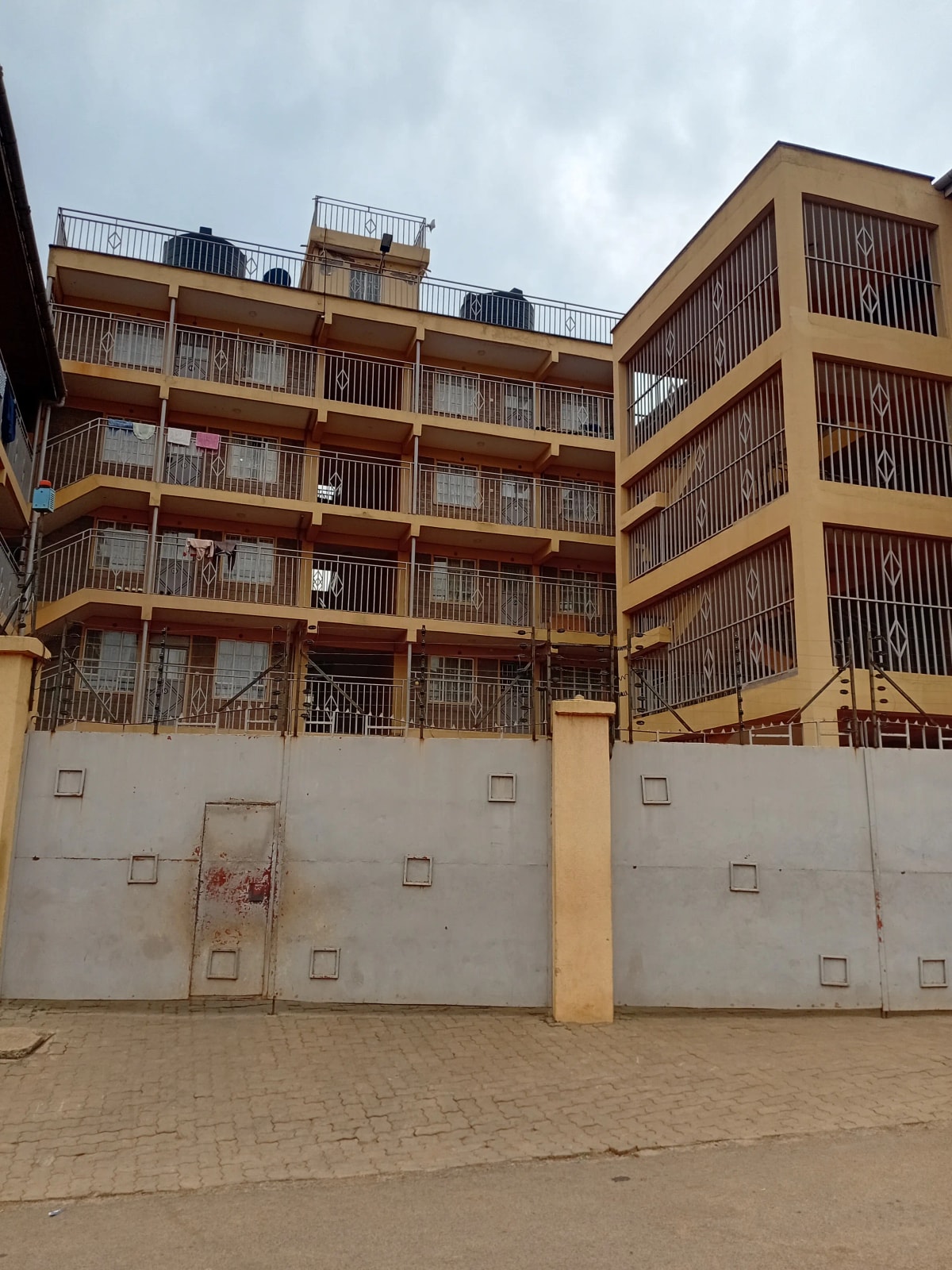 Multi-story residential building with yellow facade and balconies