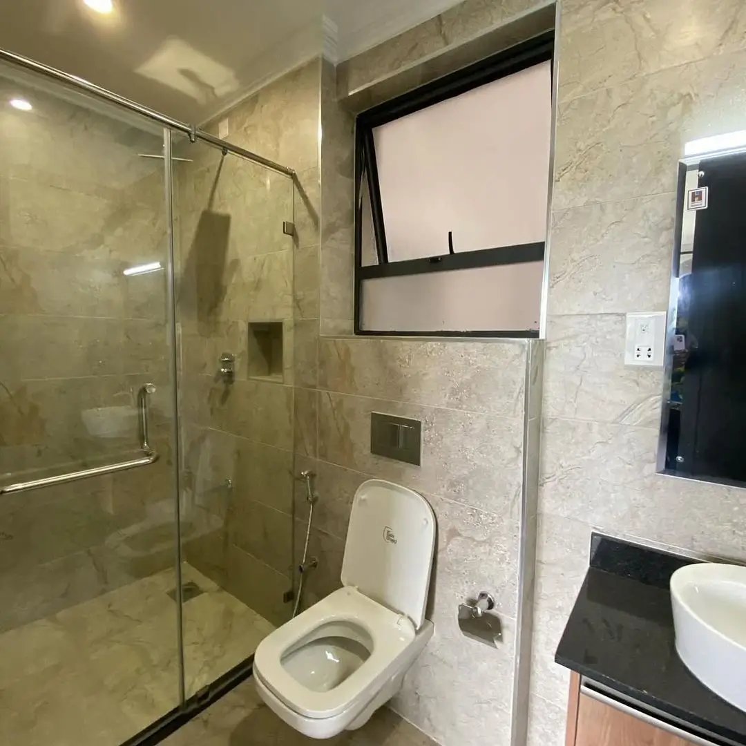 Modern bathroom with walk-in shower, toilet, and vessel sink