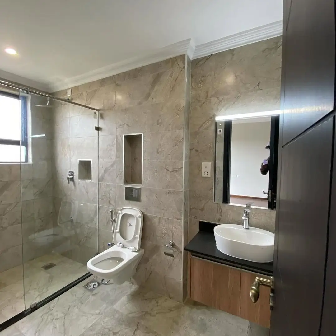 Modern bathroom with marble tiles, walk-in shower, vessel sink