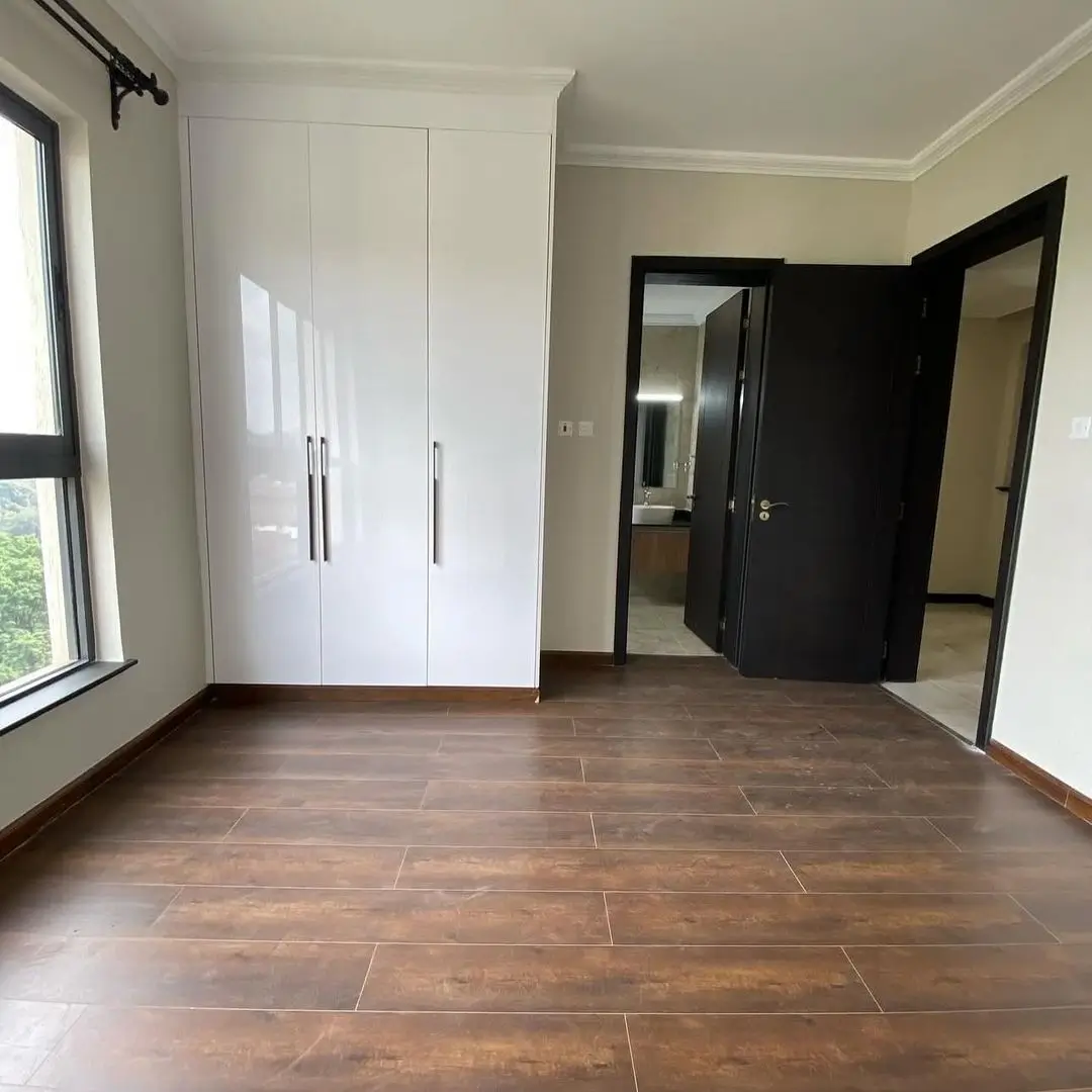 Spacious bedroom with built-in wardrobe and wooden flooring