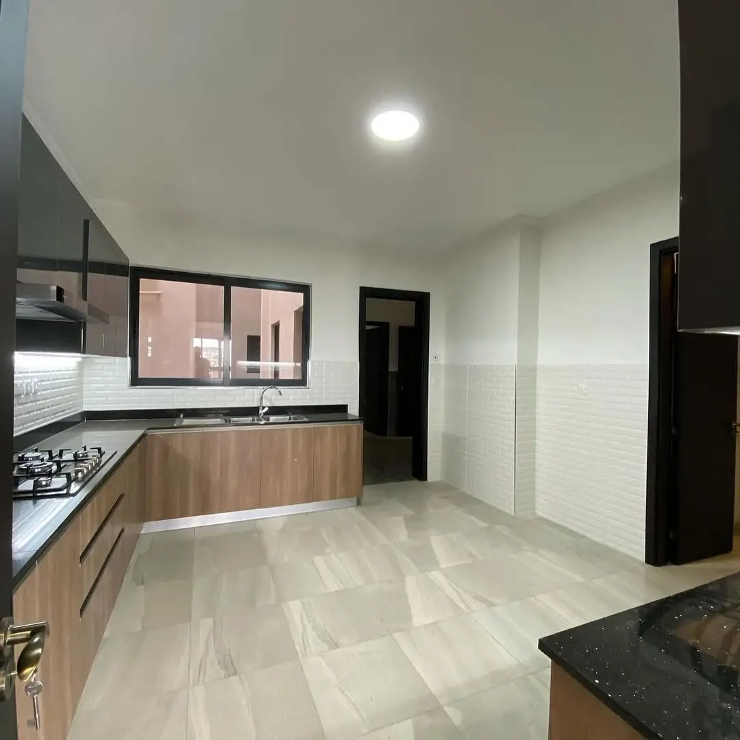 Modern kitchen with wood cabinetry, gas cooktop, white tiles