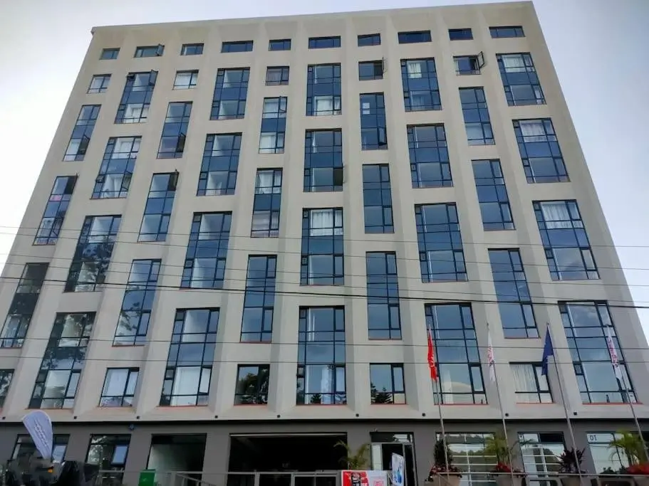 Modern multi-story residential building facade with uniform windows