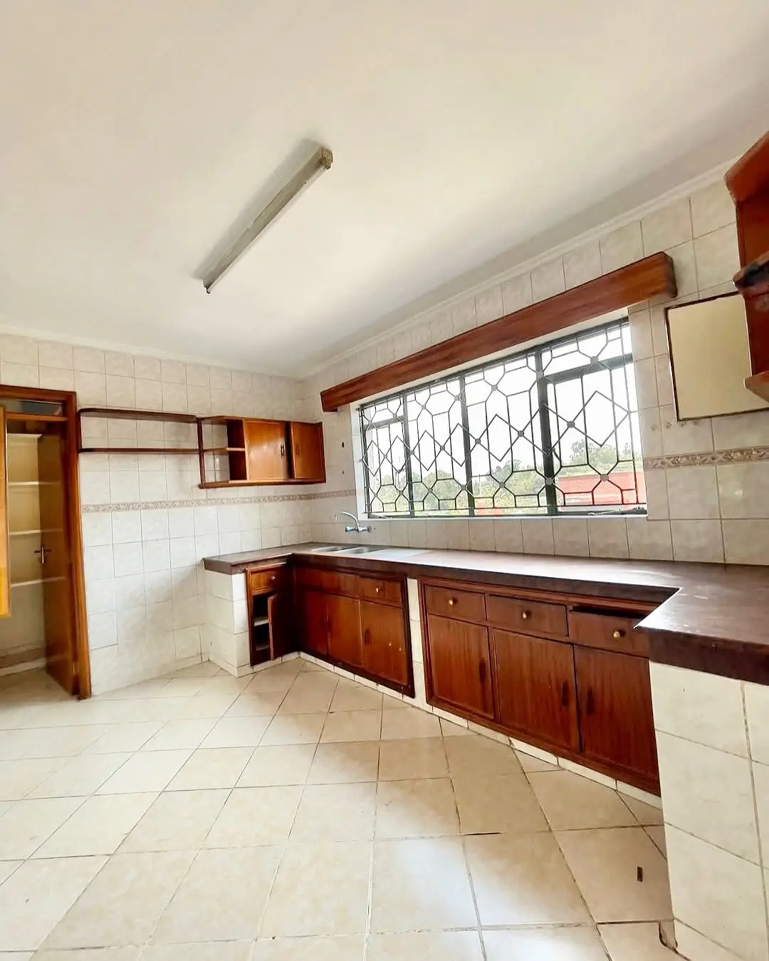 Spacious kitchen with wooden cabinetry and tiled countertops