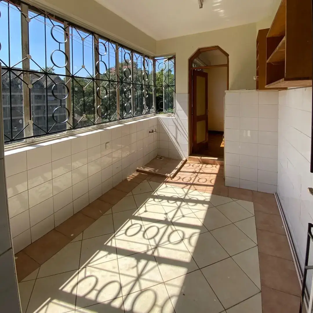 Kitchen with large barred windows overlooking garden area