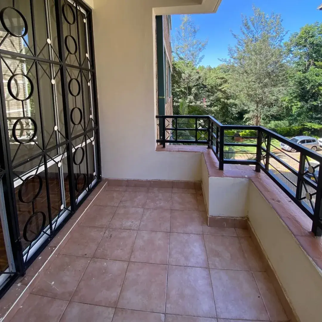 Spacious balcony with terracotta tiles, tree views, metal railings