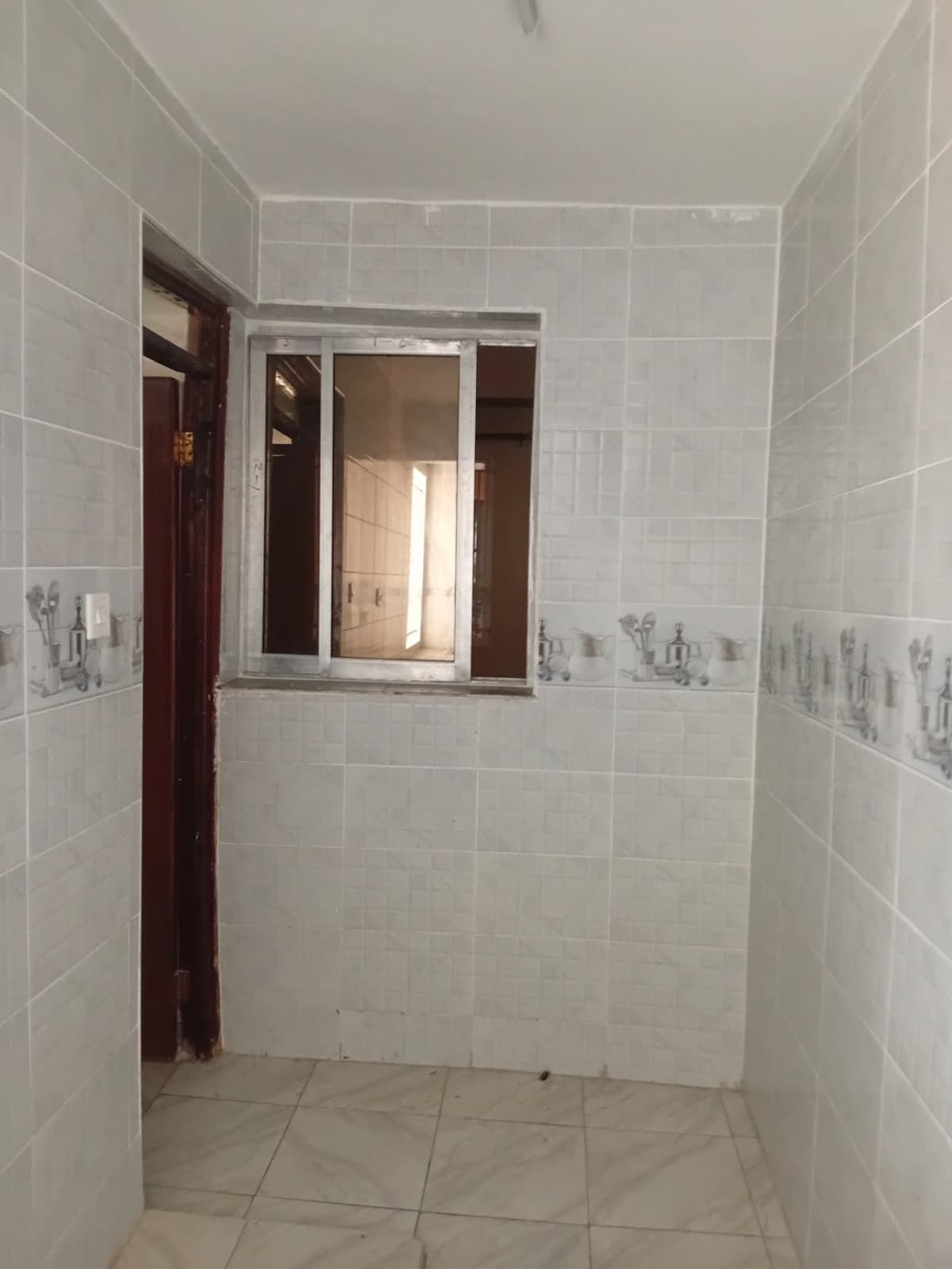 Empty bathroom with light tile walls and window
