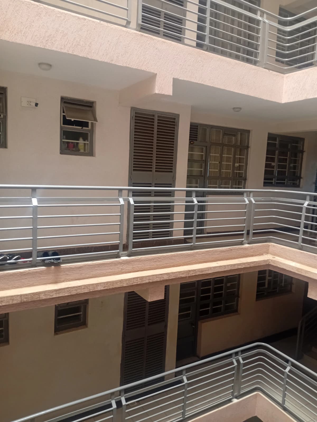 Modern balcony with horizontal metal railings and wooden flooring
