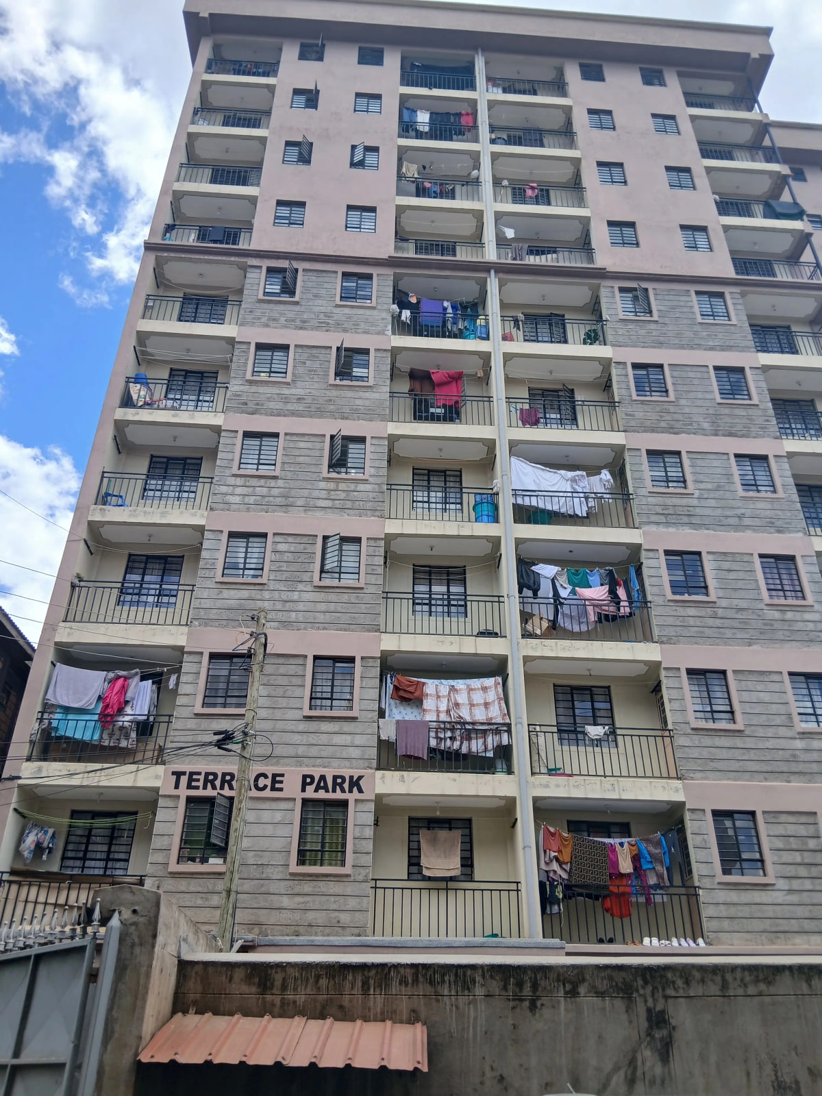 Multi-story residential building facade with balconies and signage