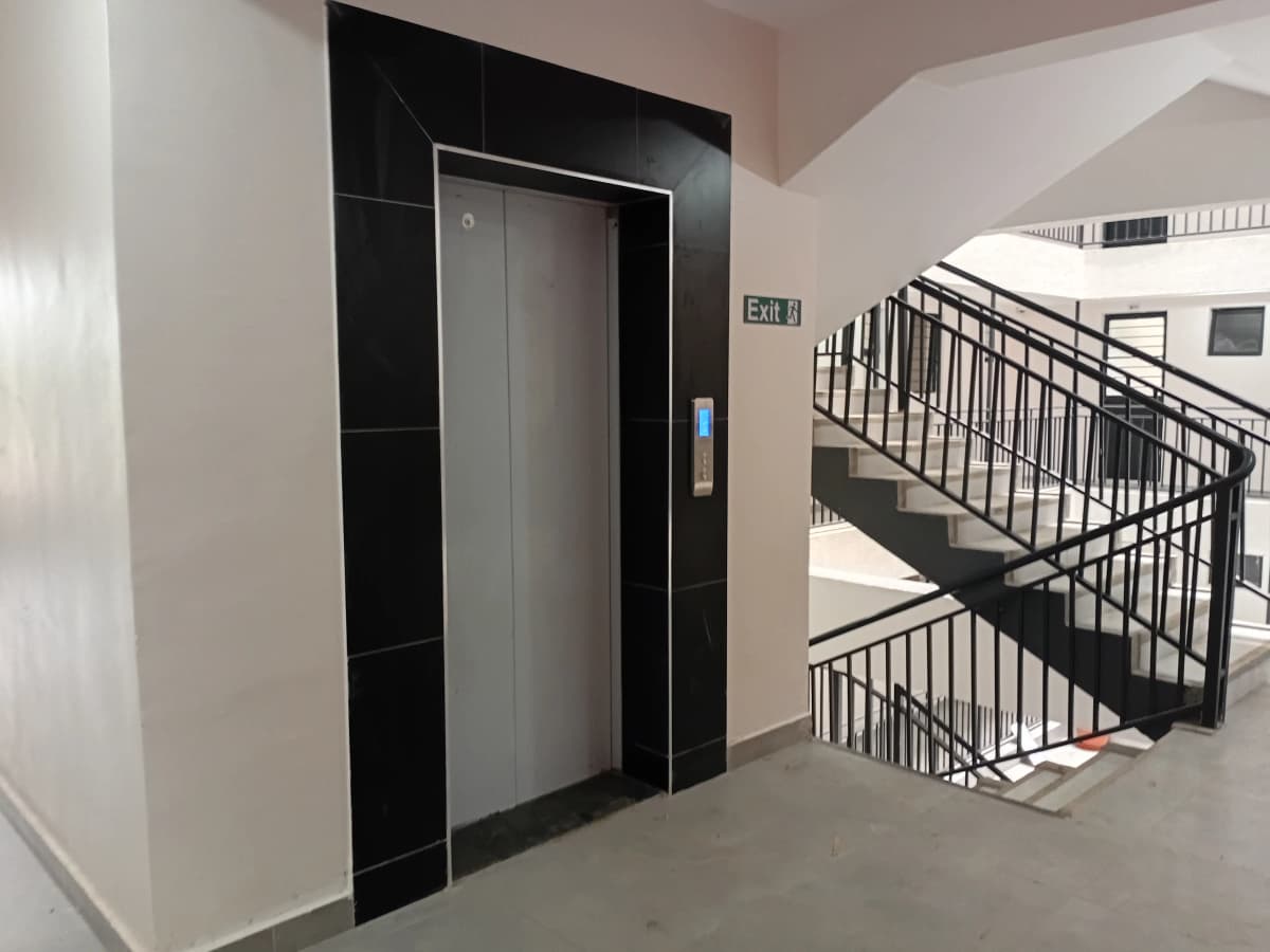 Building lobby with elevator and emergency stairwell exit