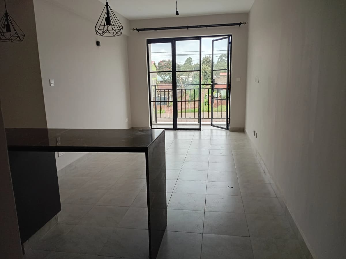 Open-plan living space with balcony access and city view