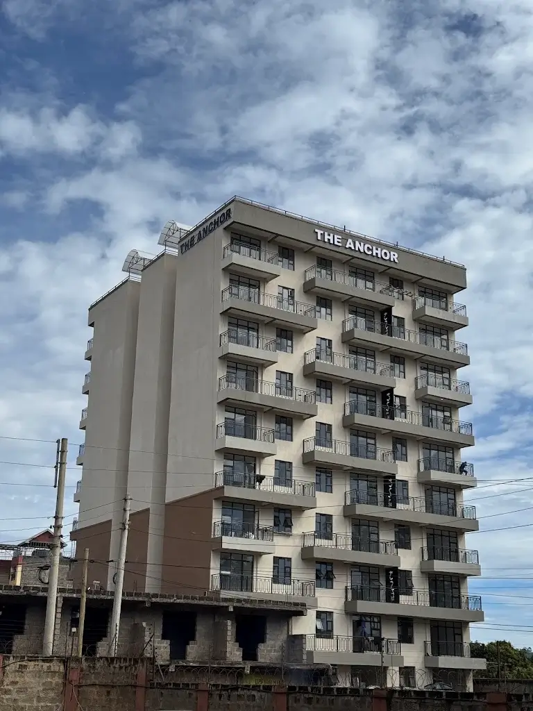 Multi-story residential building facade with balconies and signage
