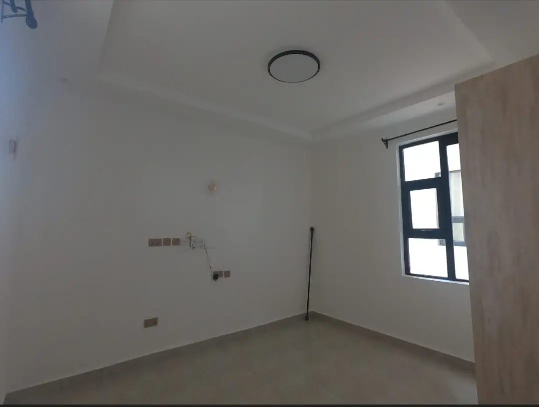 Unfurnished bedroom with recessed ceiling light and window