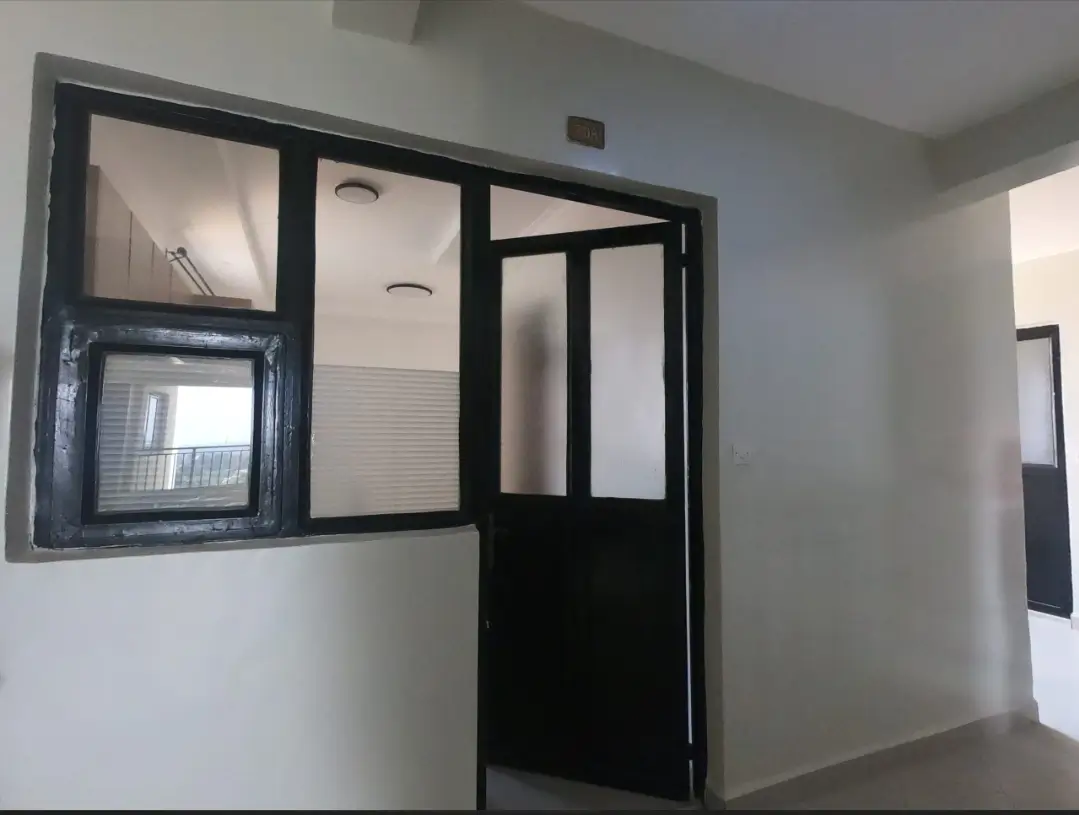 Modern lobby entrance with black-framed glass partition doors