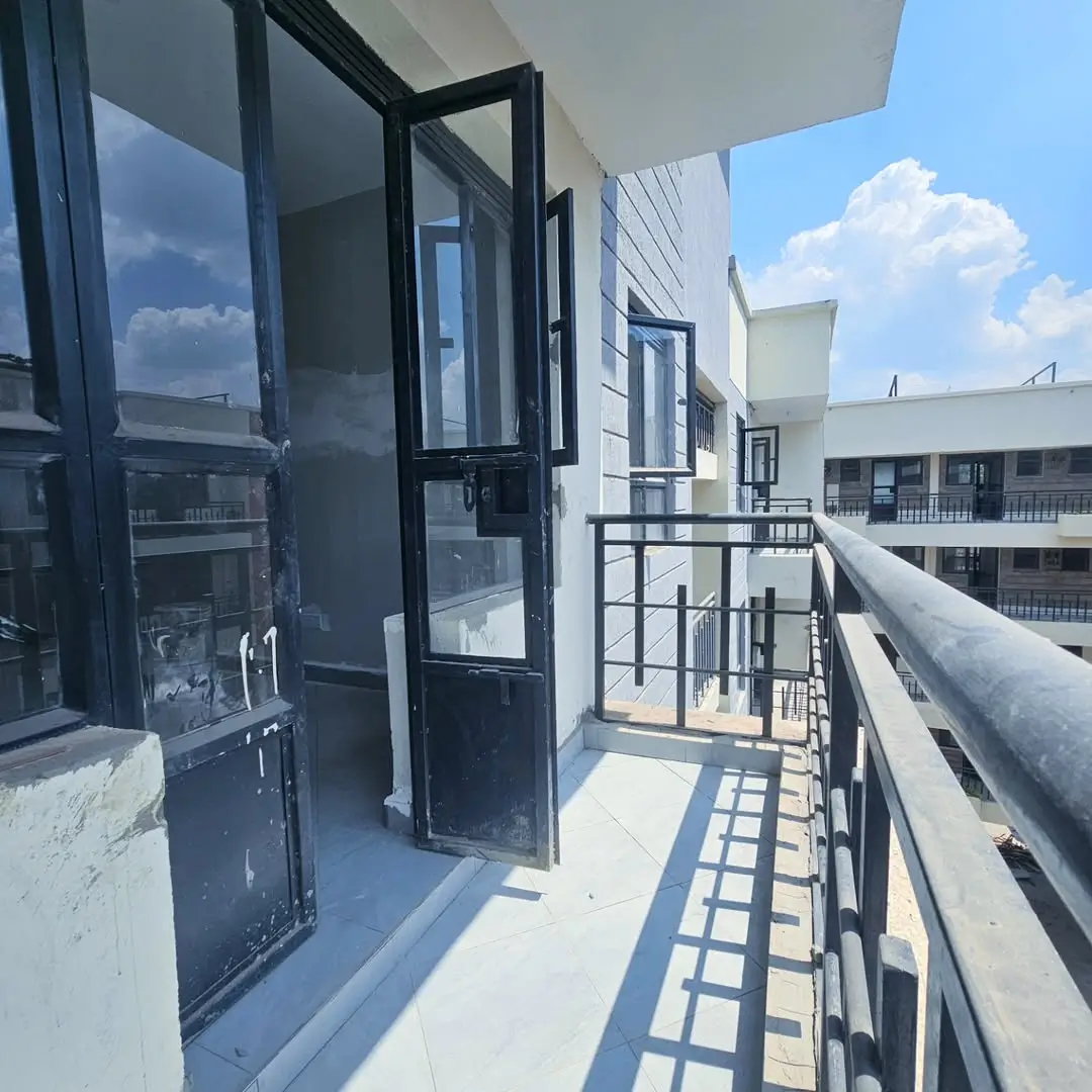 Spacious balcony with black railings and clear sky views