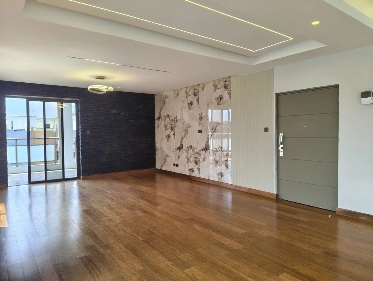 Spacious living room with wooden floors and balcony access