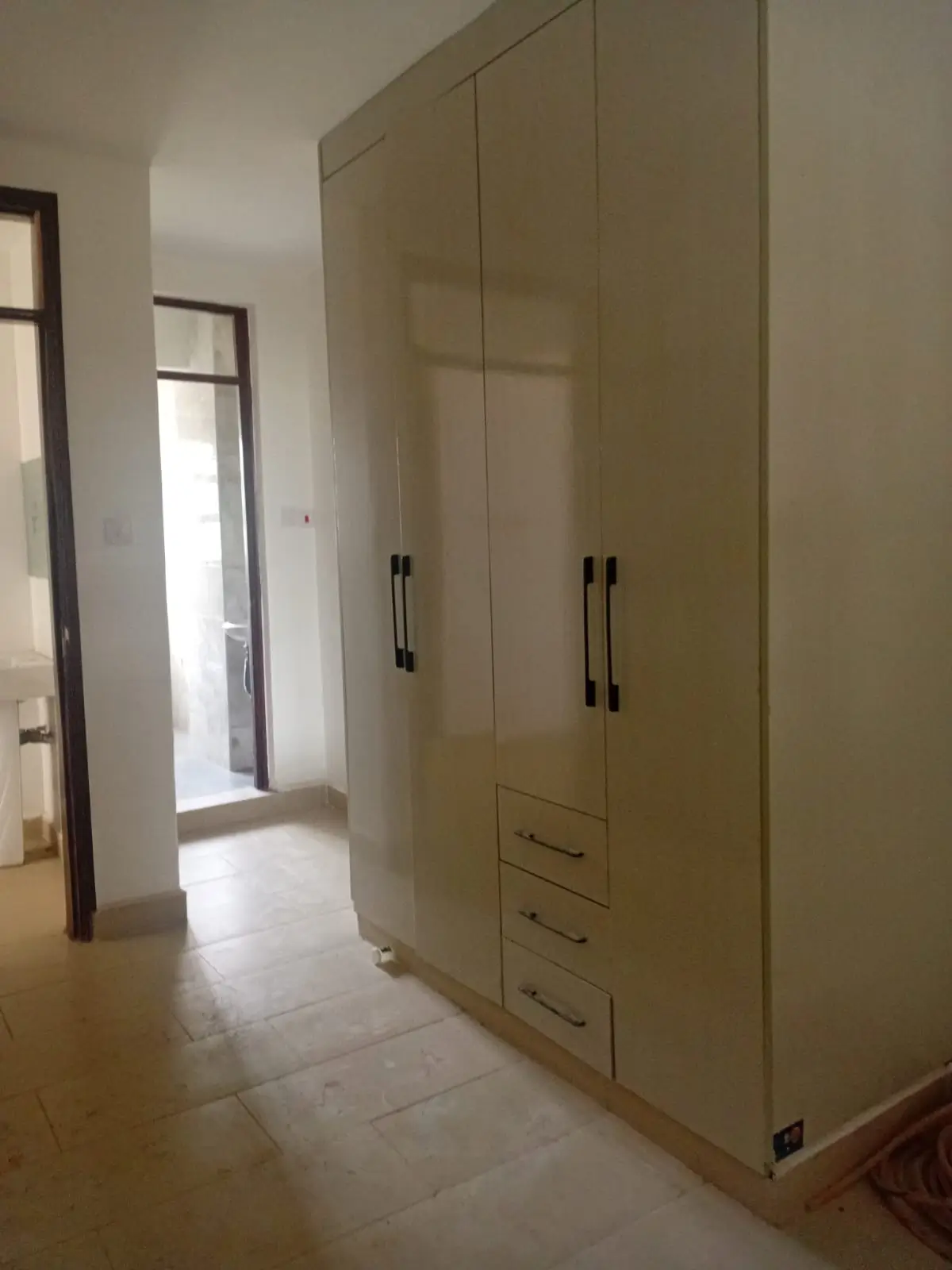 Bedroom with large built-in wardrobe and tiled flooring