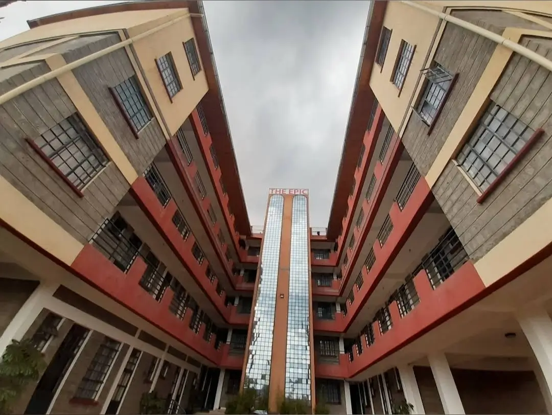 Multi-story residential building facade with red and cream exterior