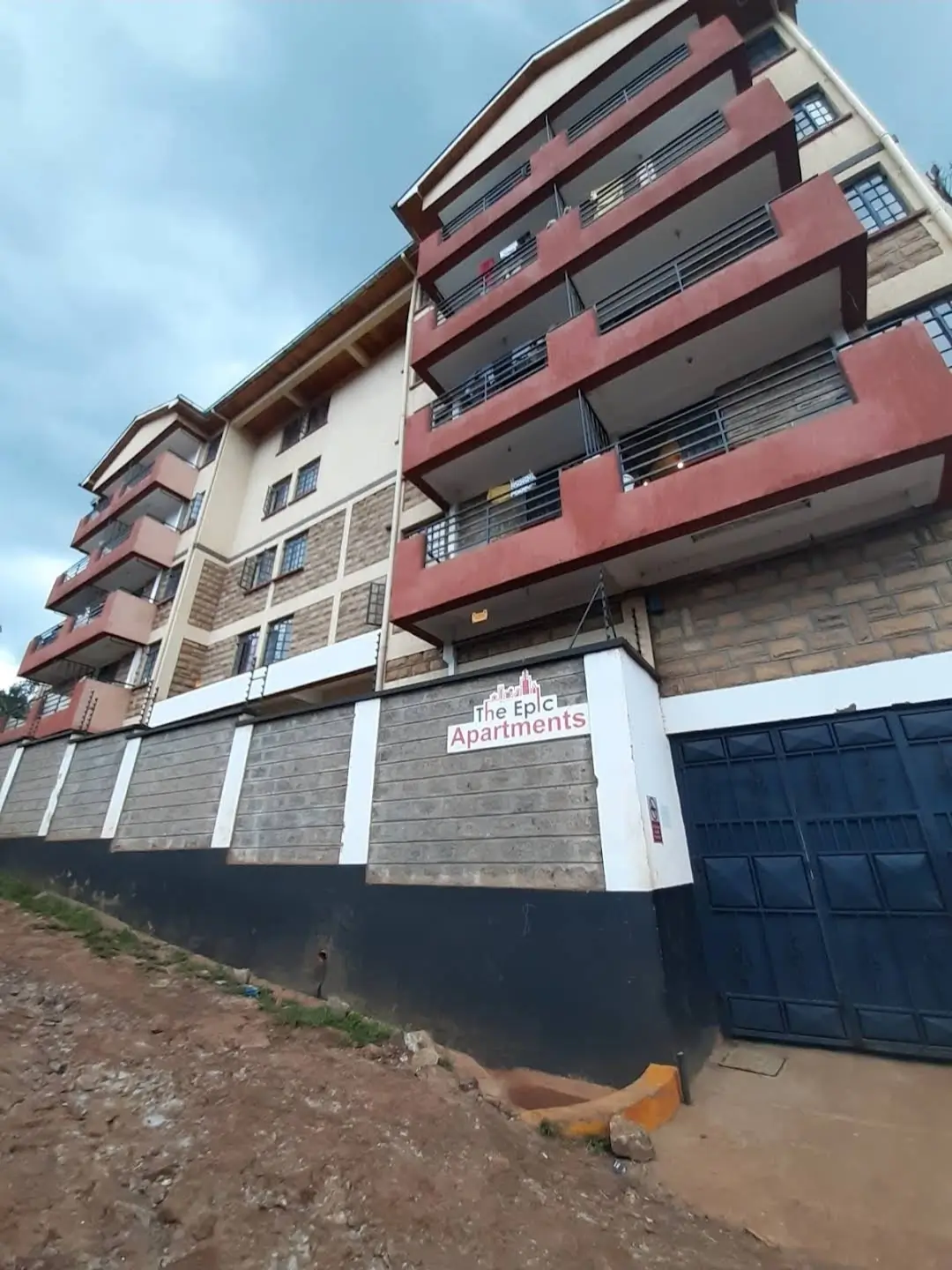 Modern multi-story residential building with red and white facade