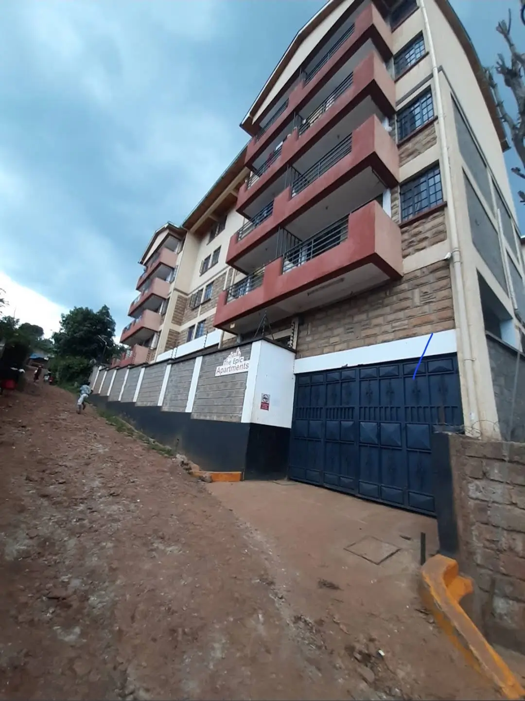 Multi-story residential building facade with gated entrance