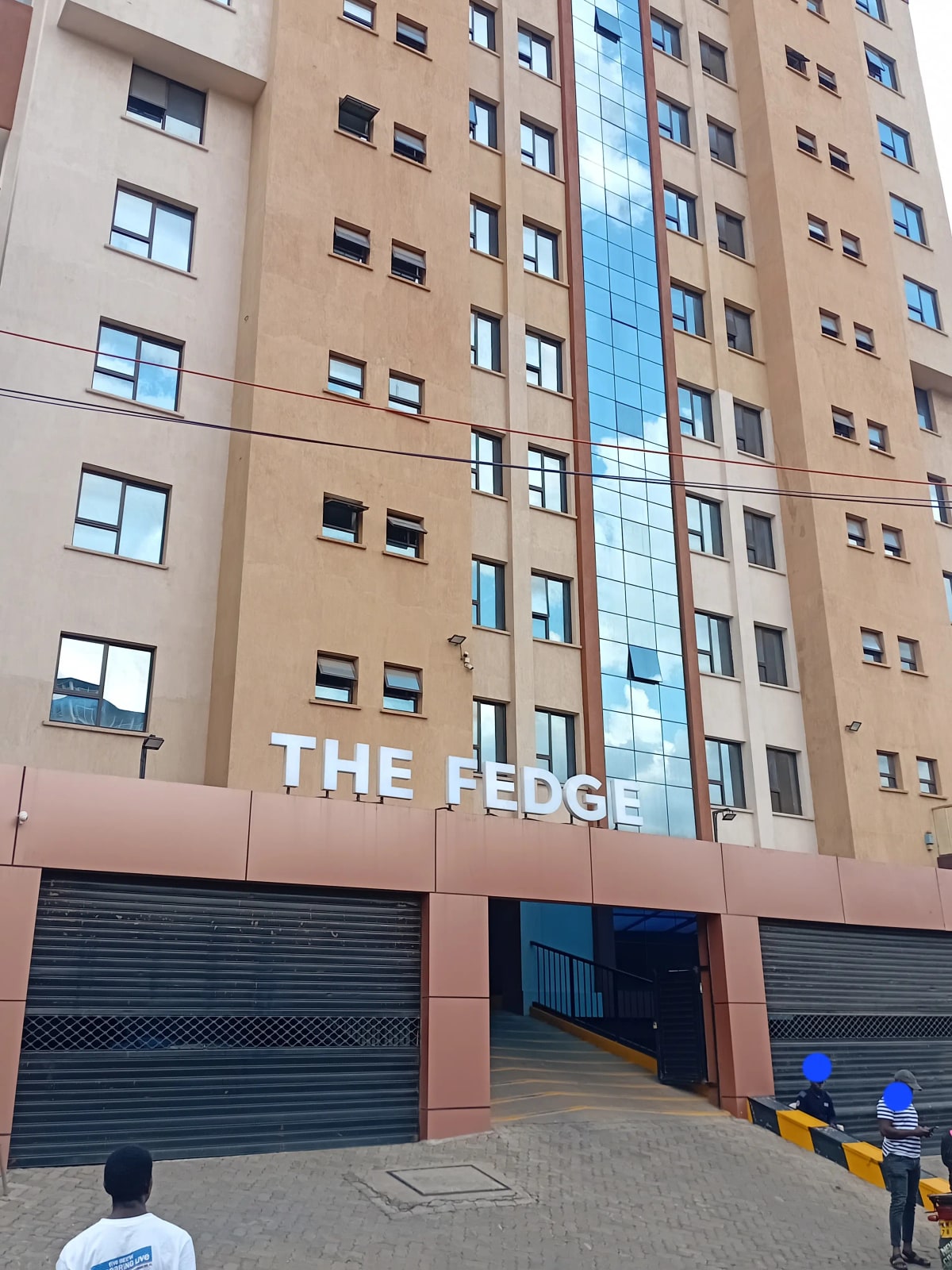 Modern apartment building facade with ground-level parking garage entrance