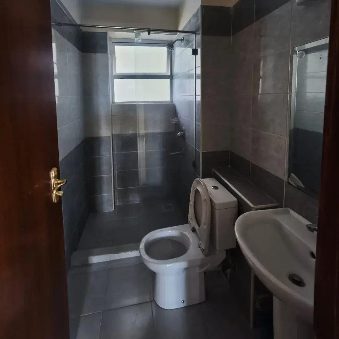 Modern bathroom with glass shower enclosure and pedestal sink