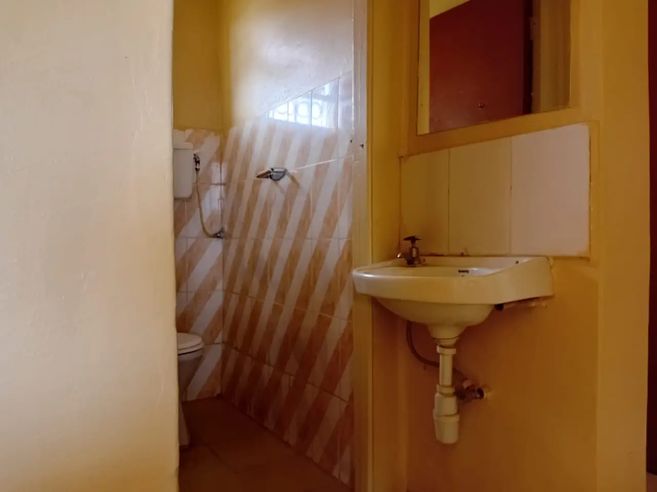 Compact bathroom with pedestal sink and shower enclosure