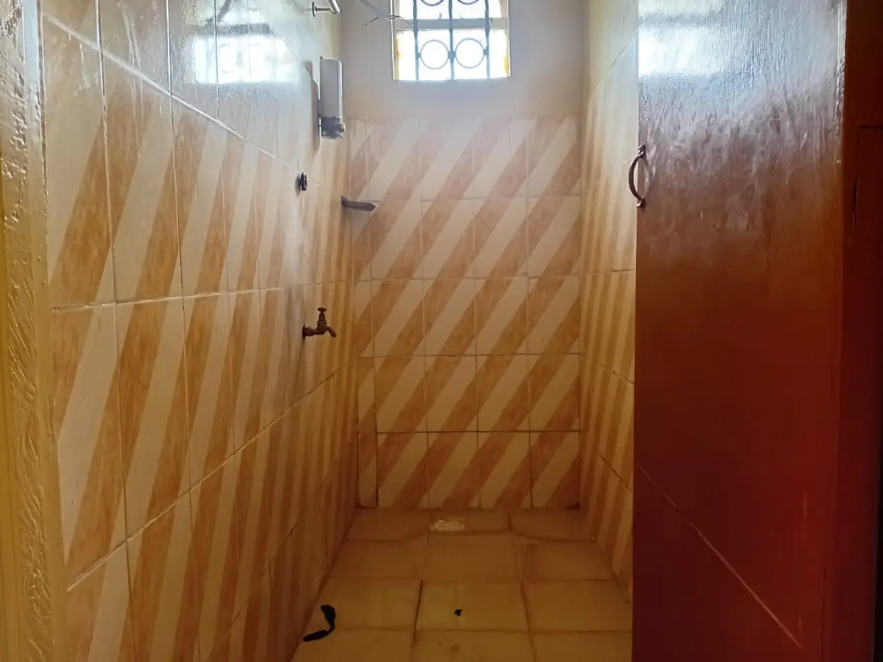 Bathroom with wood-grain tiling and shower enclosure