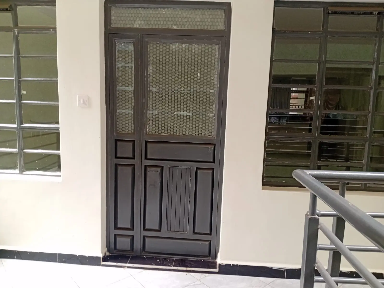 Building entrance with dark wooden door and glass windows