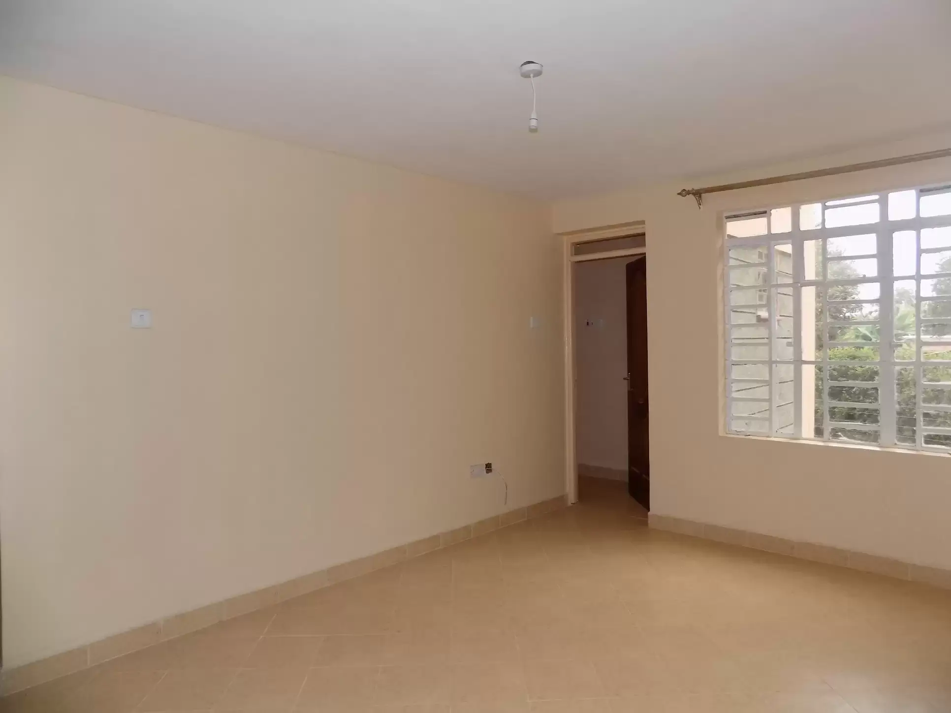 Spacious bedroom with large windows and natural light