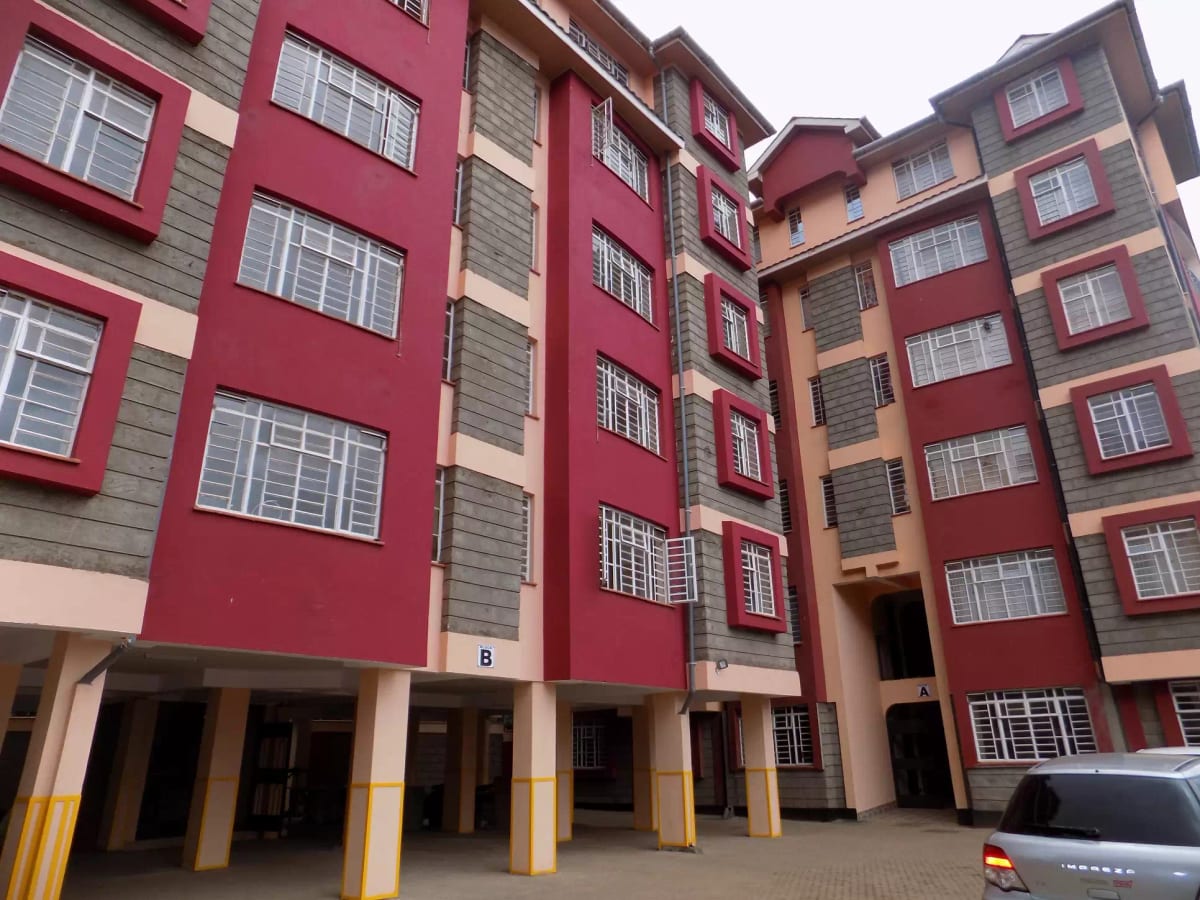 Multi-story residential building with red and beige facade