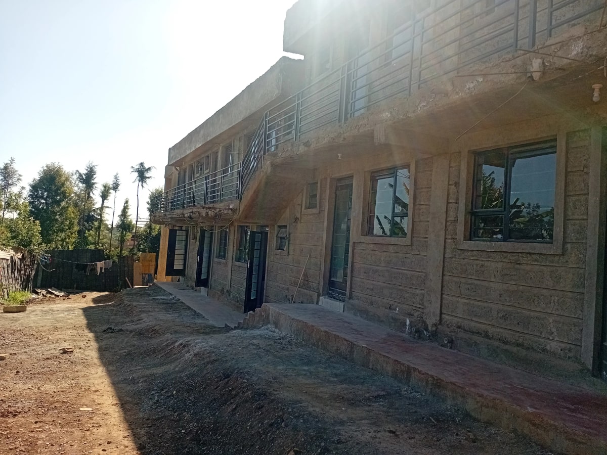 Two-story residential building with brick facade and front entrance