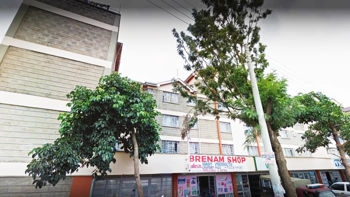 Multi-story residential building with ground-floor retail shops