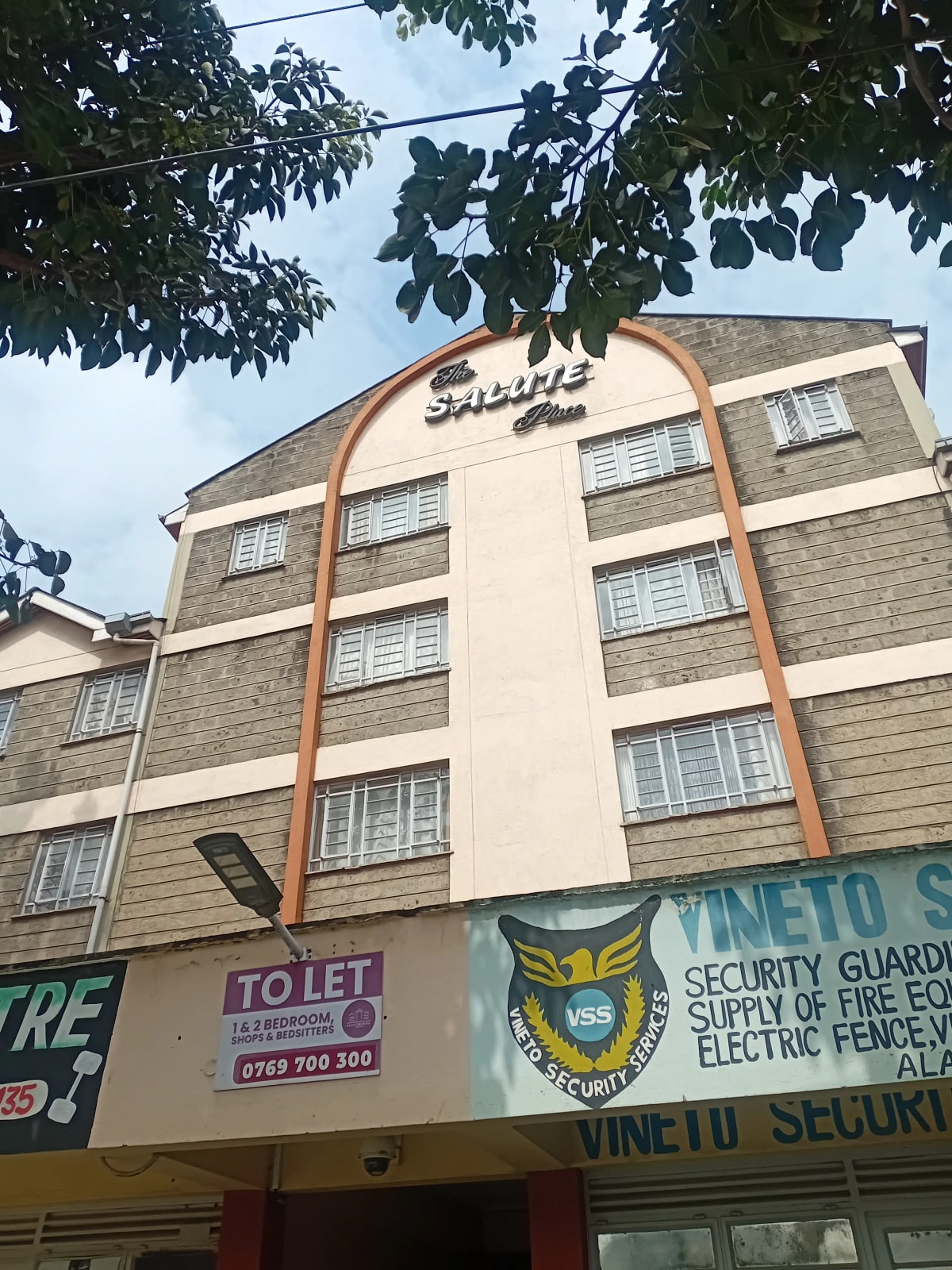 Multi-story residential building facade with ground-floor retail