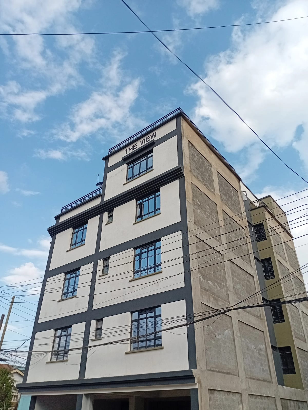 Modern multi-story residential building facade with clean lines