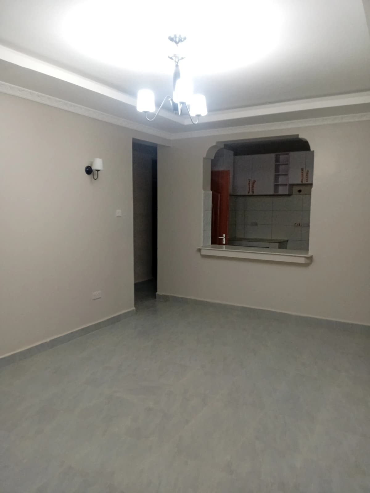 Empty living room with ceiling fan and neutral walls