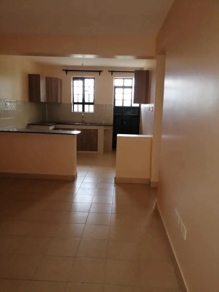 Open-plan kitchen with dining counter overlooking living area