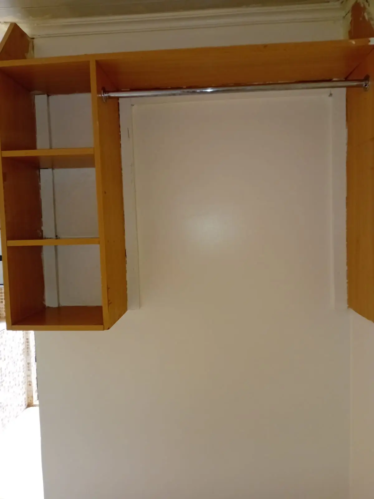 Bedroom with wooden built-in wardrobe and clothing rail