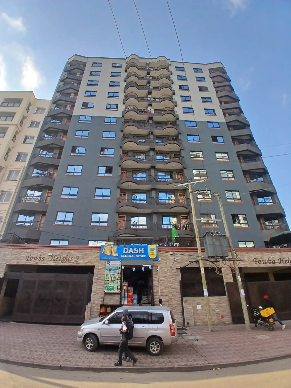 Multi-story residential building facade with ground floor retail