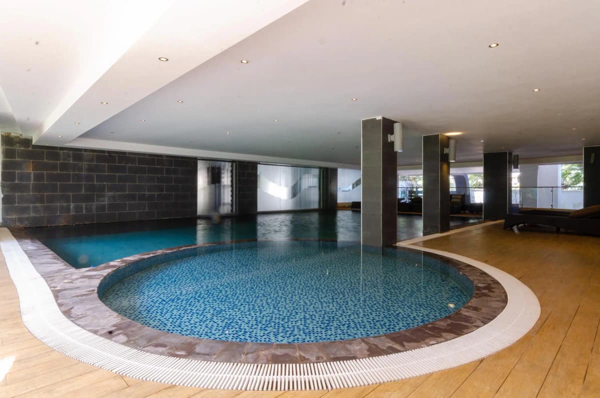 Indoor swimming pool with circular design and ambient lighting