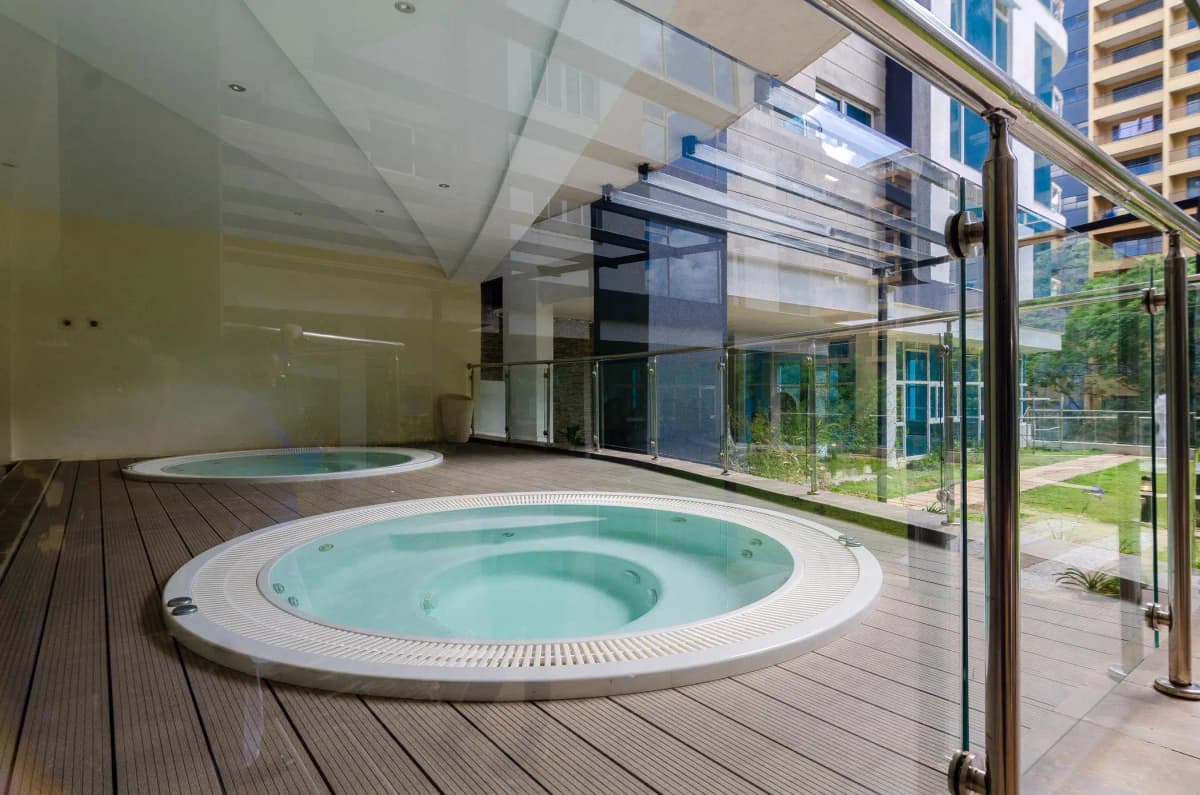 Modern spa pool area with jacuzzi and wooden deck