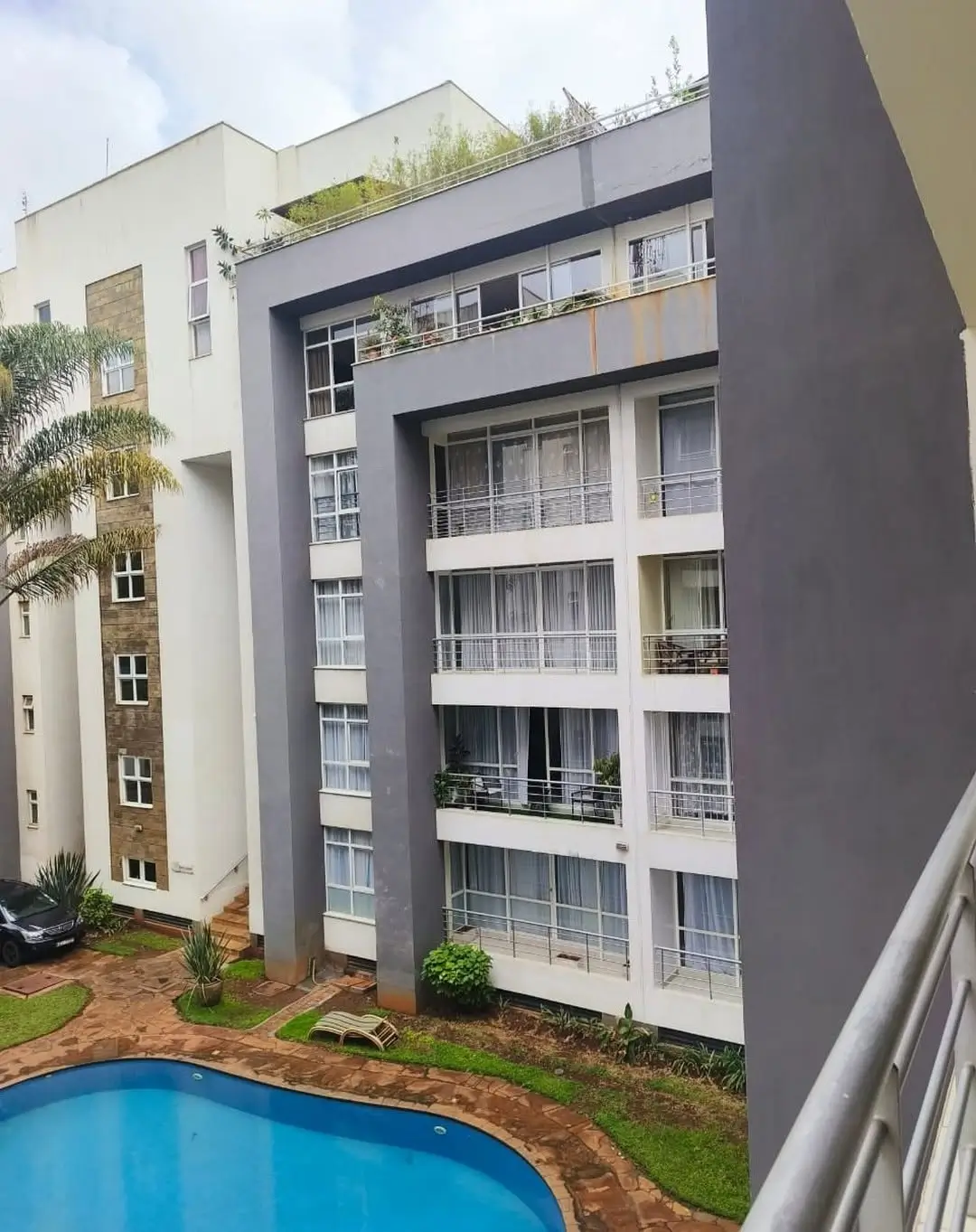 Modern multi-story residential building with swimming pool