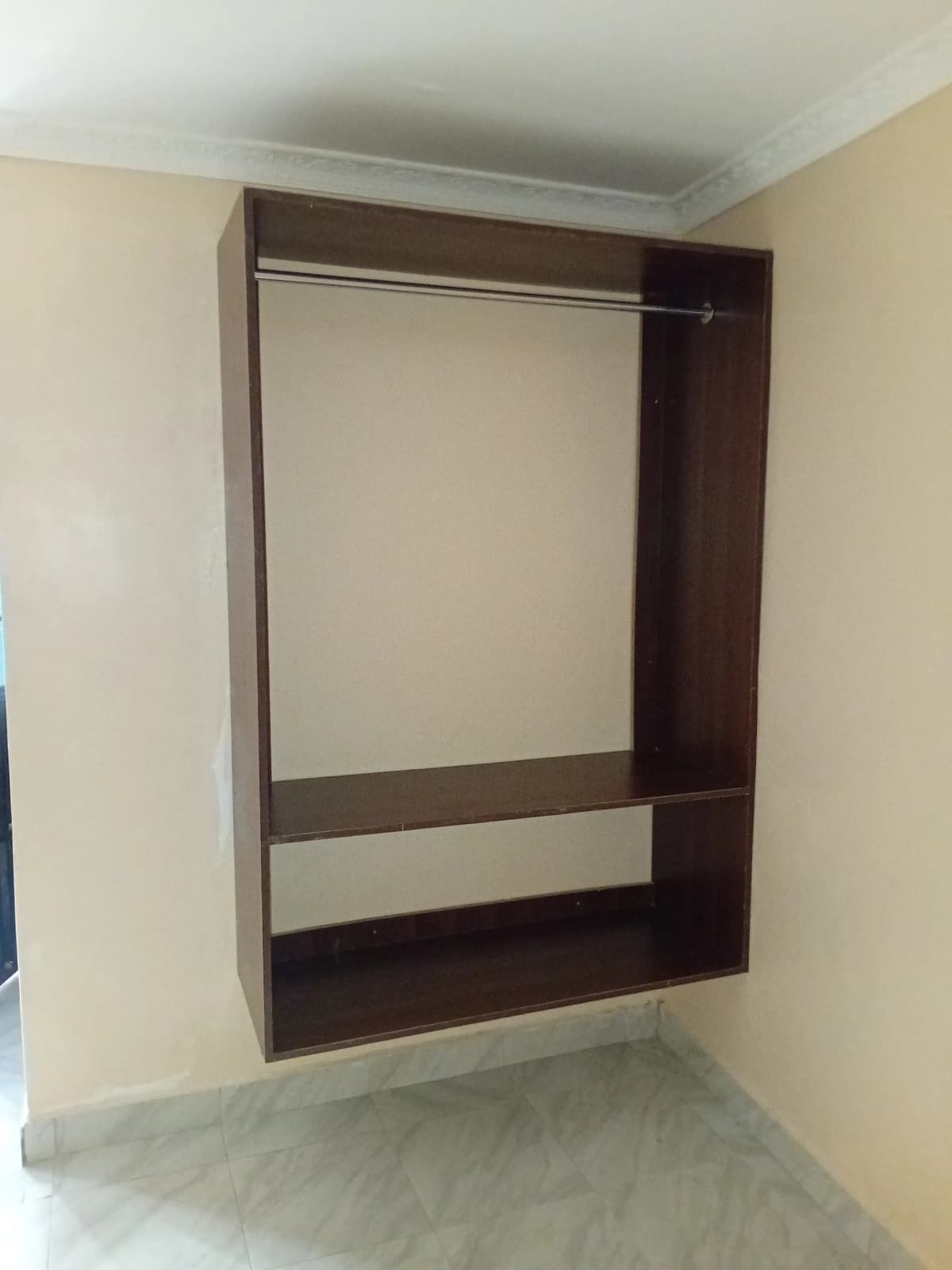 Built-in wardrobe with open frame structure, dark wood finish